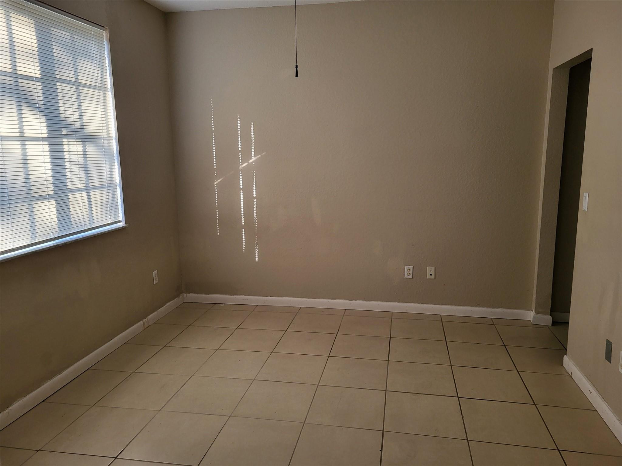 1957 Freeport Drive, Unit 1957 Riviera Beach, FL 33404 - Photo 7 of 14 an empty room with windows