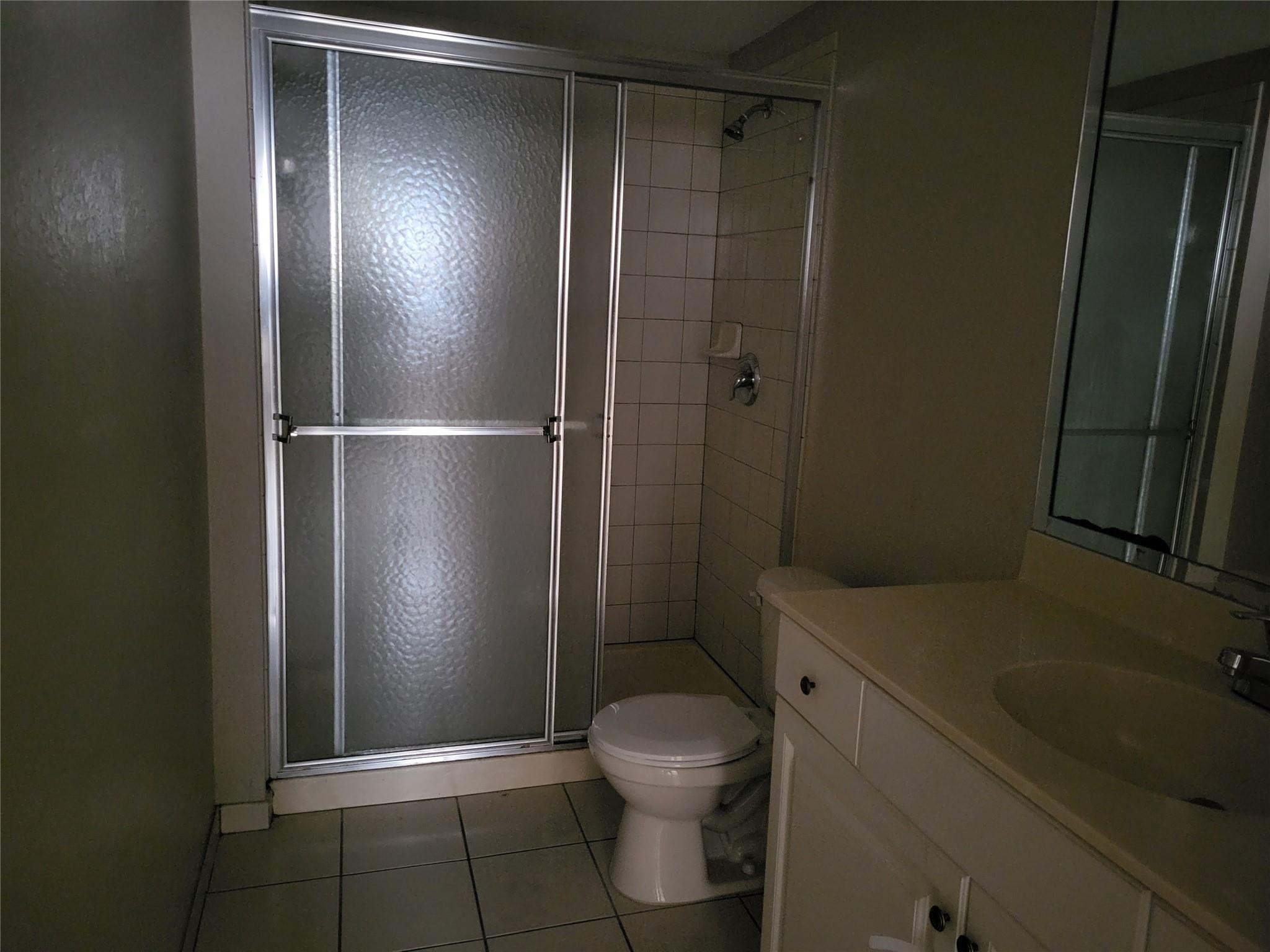 1957 Freeport Drive, Unit 1957 Riviera Beach, FL 33404 - Photo 8 of 14 a bathroom with a toilet and a shower