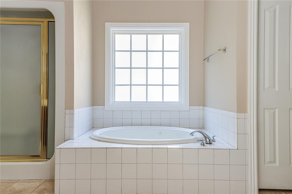 6150 Six Mile Cove Road Cumming, GA 30041 - Photo 8 of 27 a bathroom with a bathtub and window