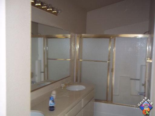 1546 Kings Road Palmdale, CA 93551 - Photo 5 of 7 a bathroom with a granite countertop shower sink and mirror