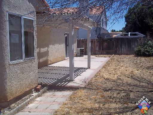 1546 Kings Road Palmdale, CA 93551 - Photo 7 of 7 a view of a backyard with wooden fence