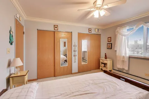 a bedroom with a bed and a chair