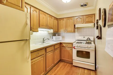 a kitchen with a stove top oven sink and refrigerator