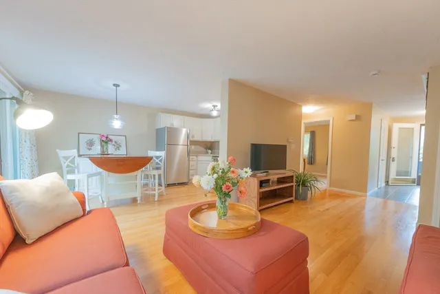a living room with furniture a dining table and a chandelier