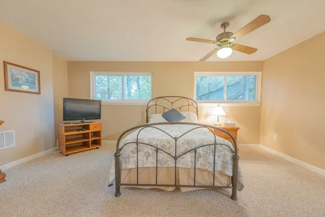 a bedroom with a bed and a ceiling fan