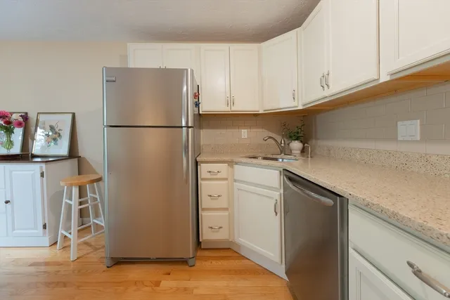 a kitchen with a refrigerator and a sink