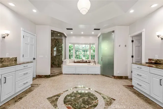 a large spacious bathroom with a granite countertop tub sink and mirror