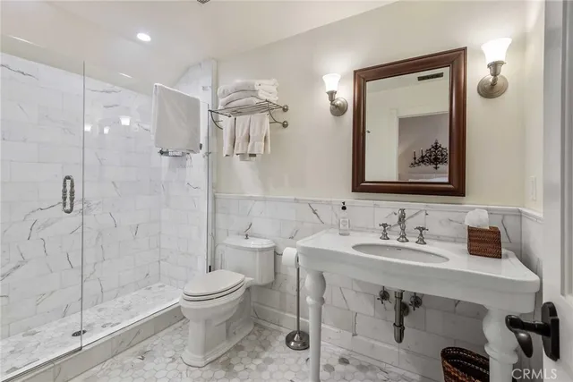 a bathroom with a toilet sink and shower