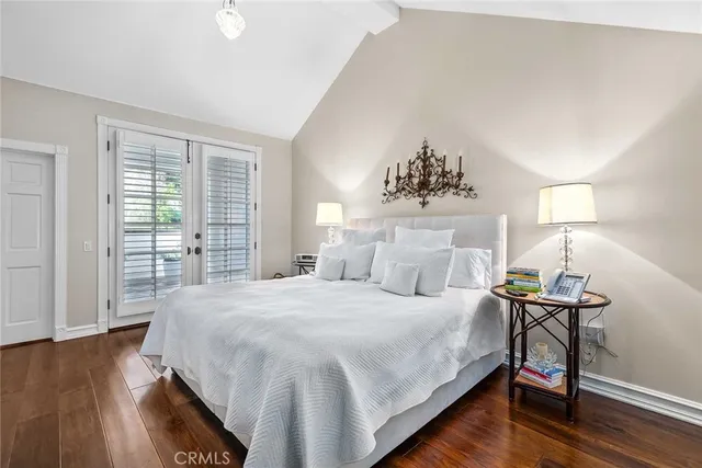 a bedroom with a bed table and a window
