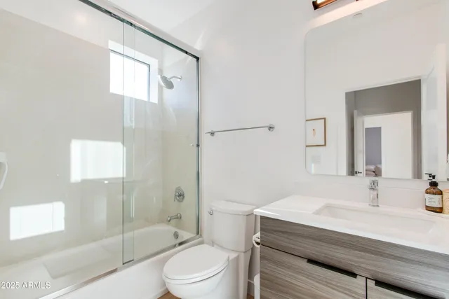 a bedroom with a bed and a mirror