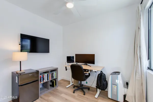 a bedroom with a bed and a wooden floor