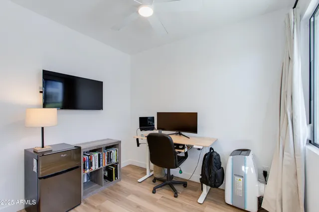 a bedroom with a bed and a wooden floor
