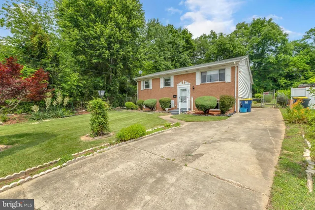 a front view of a house with garden and patio