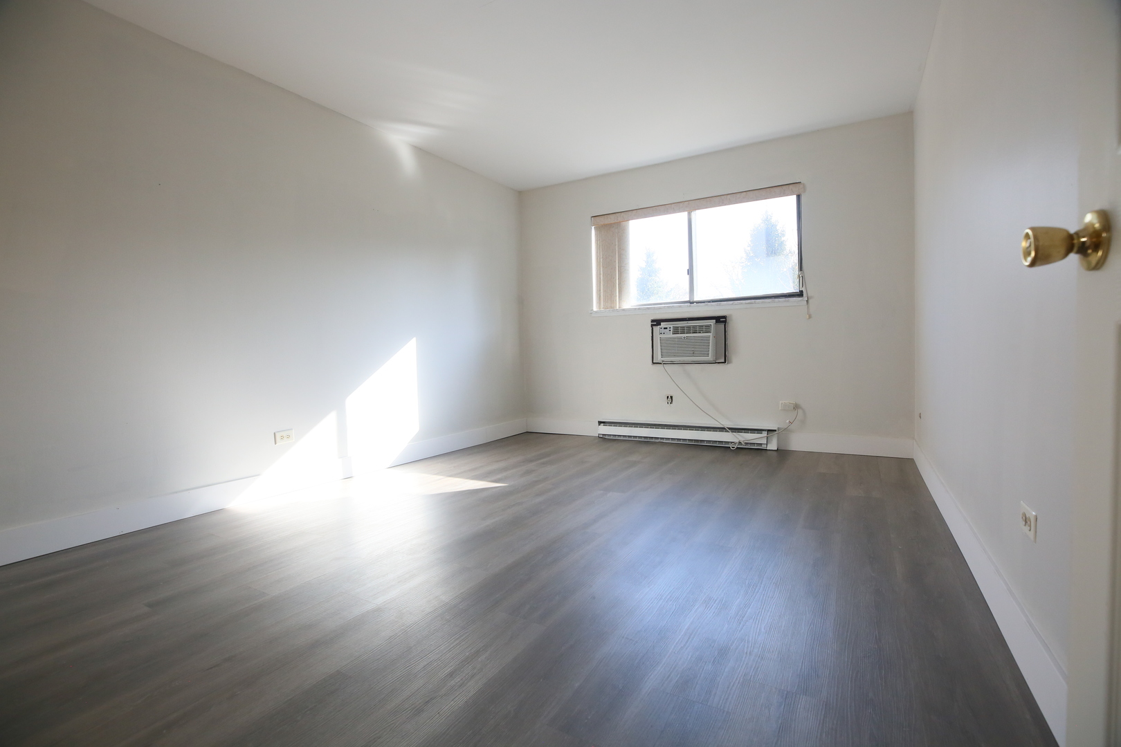 832 East Old Willow Road, Unit 105 Prospect Heights, IL 60070 - Photo 11 of 15 an empty room with wooden floor and windows
