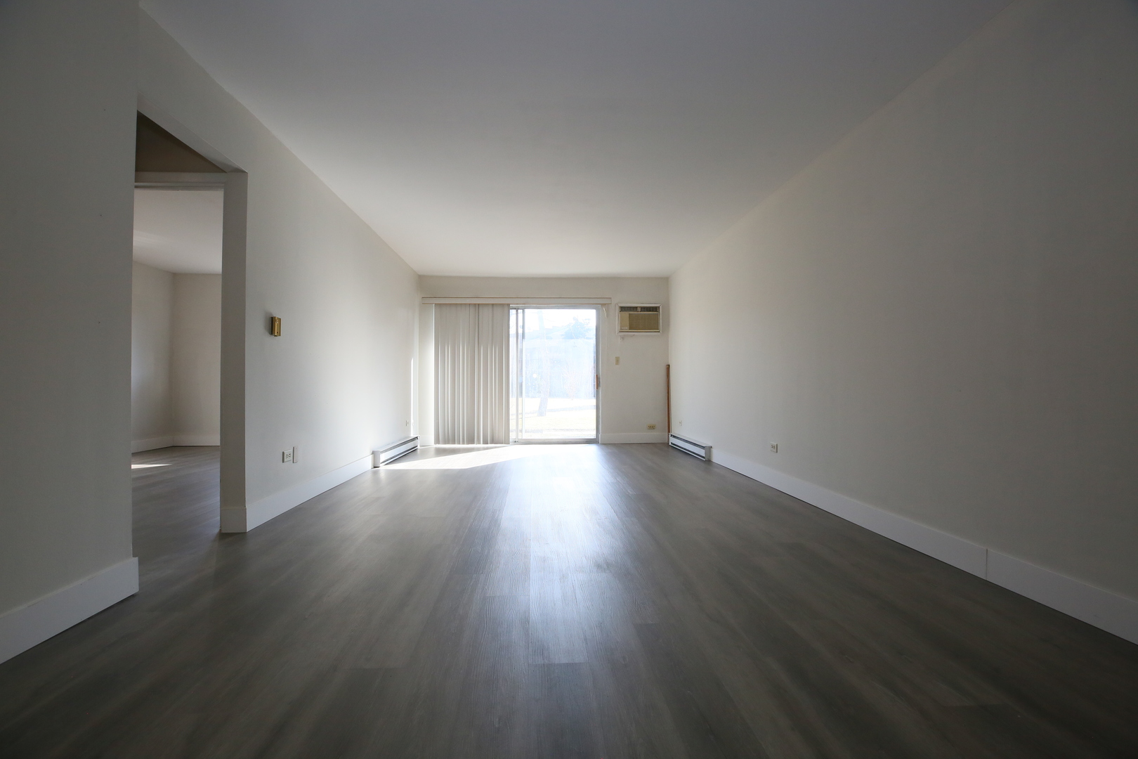 832 East Old Willow Road, Unit 105 Prospect Heights, IL 60070 - Photo 4 of 15 a view of an empty room with wooden floor and window