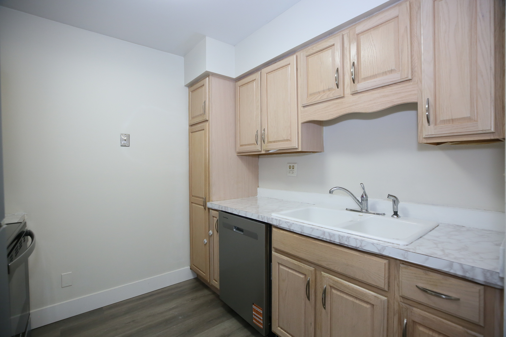 832 East Old Willow Road, Unit 105 Prospect Heights, IL 60070 - Photo 5 of 15 a kitchen with stainless steel appliances granite countertop a sink and dishwasher with wooden cabinets