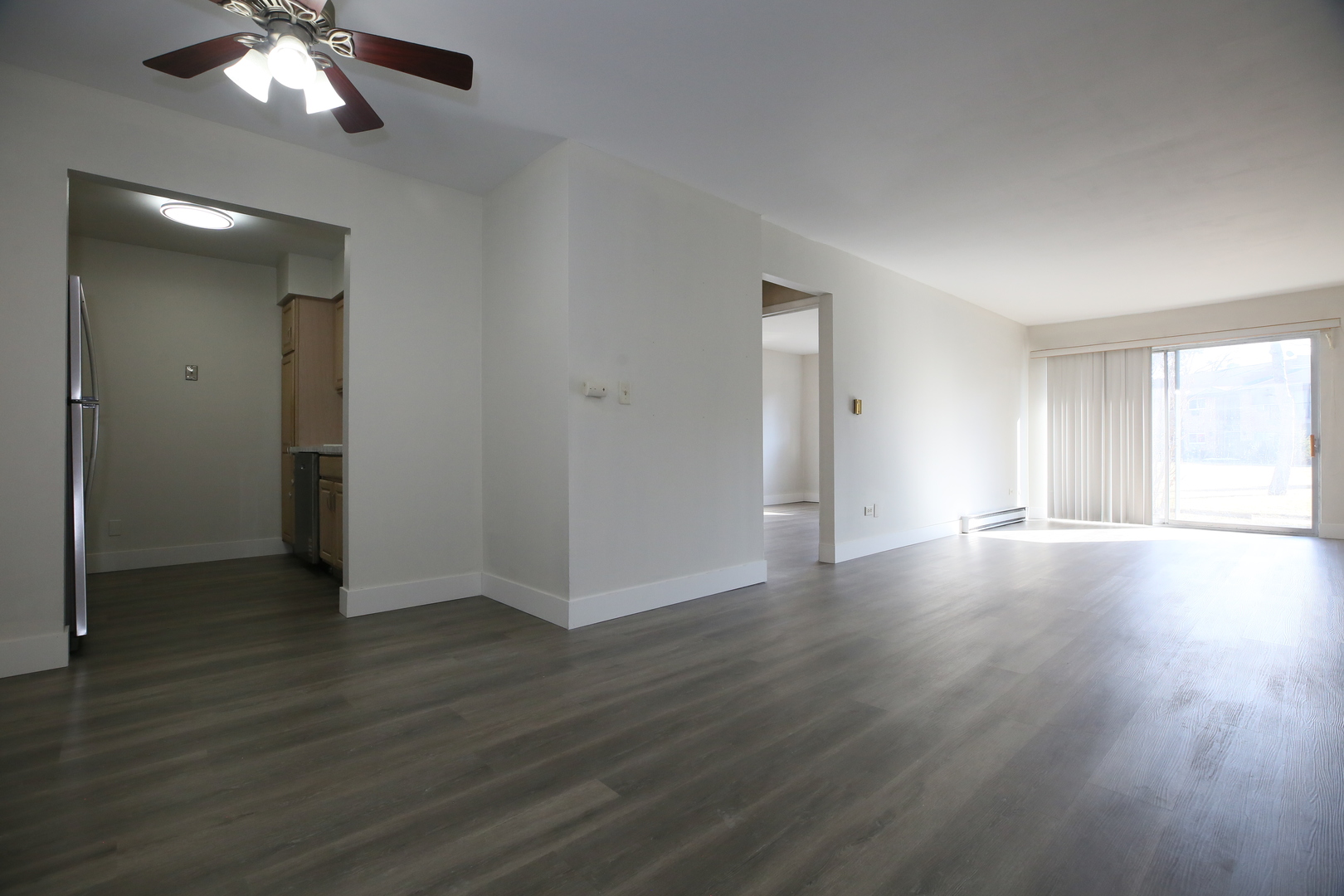 832 East Old Willow Road, Unit 105 Prospect Heights, IL 60070 - Photo 8 of 15 a view of a livingroom with wooden floor and a ceiling fan