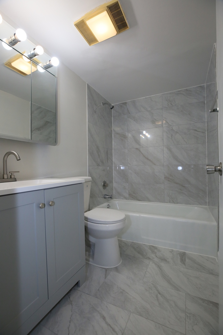 832 East Old Willow Road, Unit 105 Prospect Heights, IL 60070 - Photo 9 of 15 a bathroom with a toilet sink and mirror