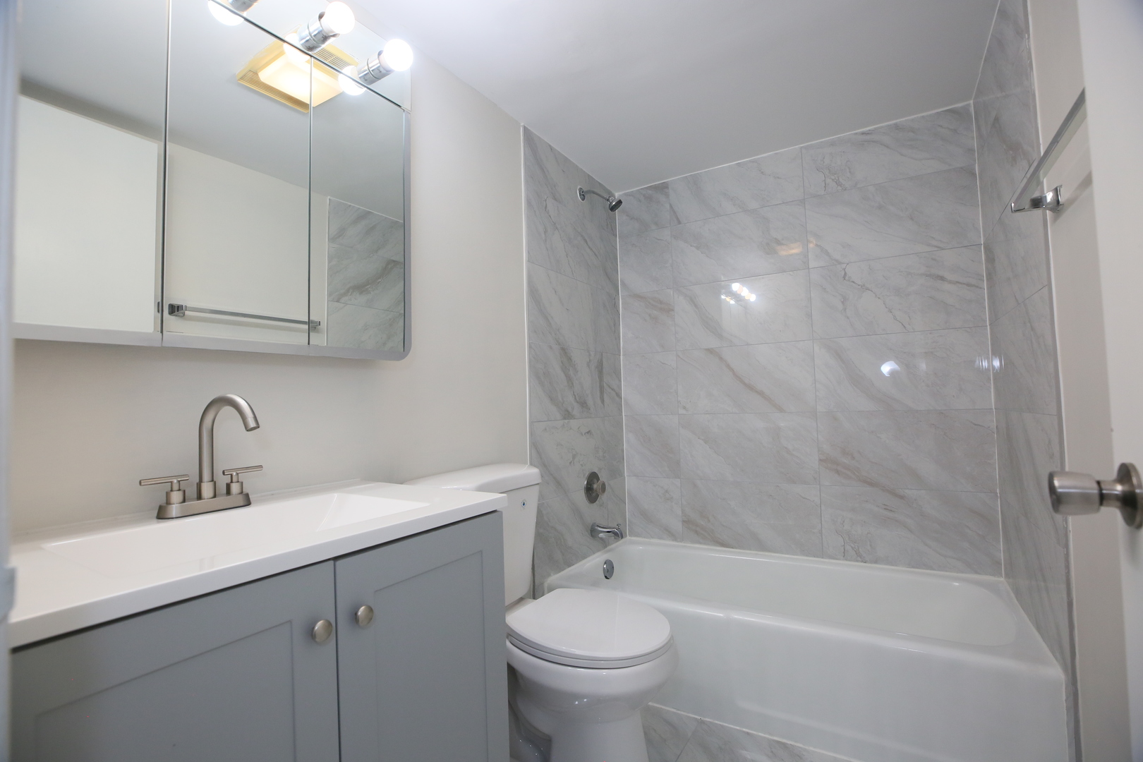832 East Old Willow Road, Unit 105 Prospect Heights, IL 60070 - Photo 10 of 15 a bathroom with a sink a toilet and a bathtub