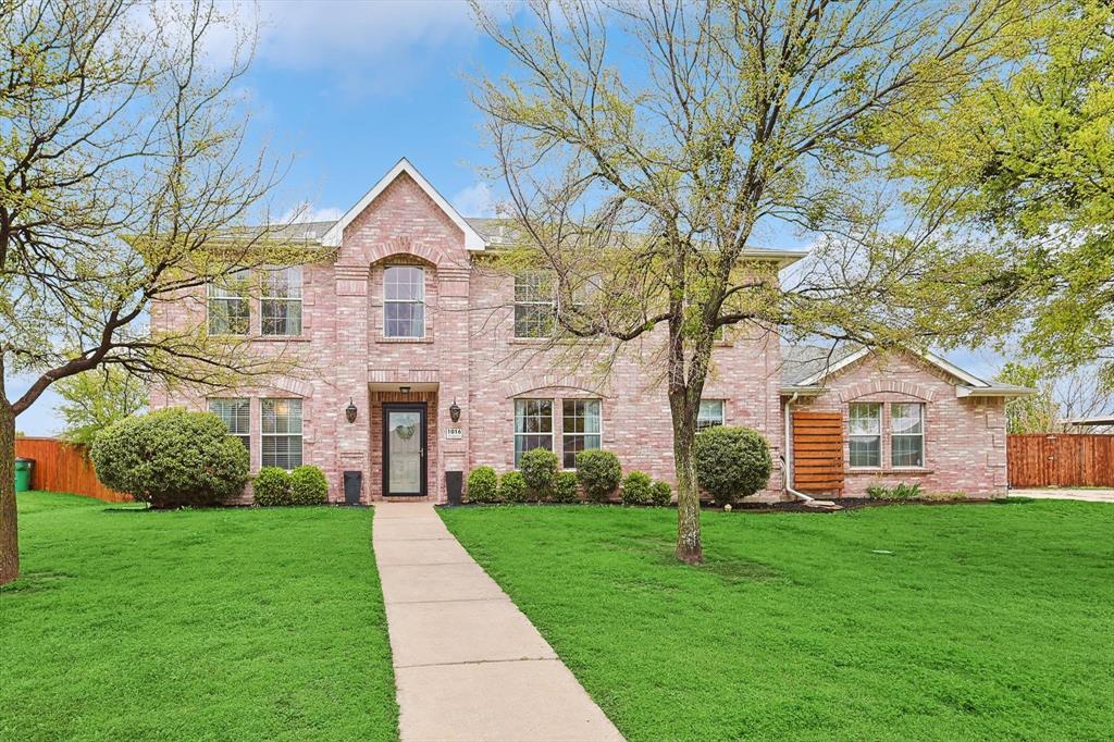 Traditional-style home featuring brick siding