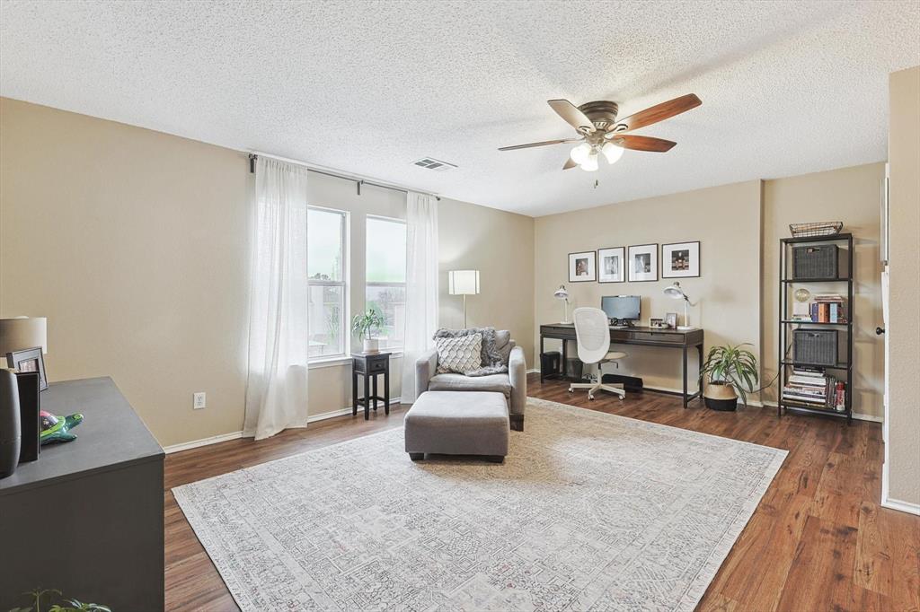 1016 Ridgetop Drive Justin, TX 76247 - Photo 21 of 40 Living area with an office area, a textured ceiling, ceiling fan, and dark wood-style floors