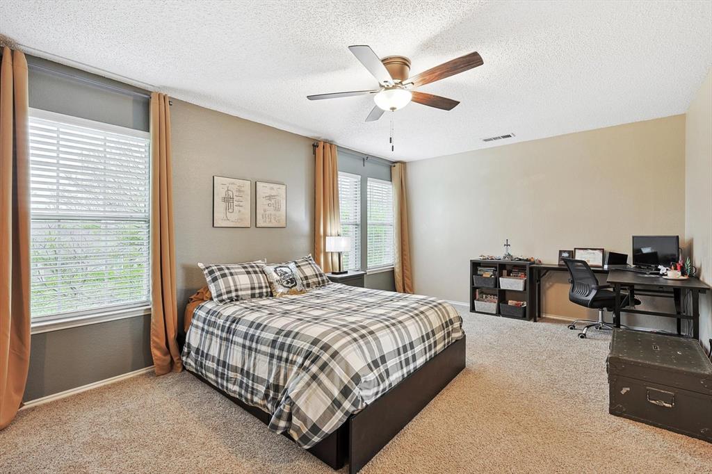 1016 Ridgetop Drive Justin, TX 76247 - Photo 23 of 40 Bedroom with a textured ceiling, carpet floors, an office area, and ceiling fan