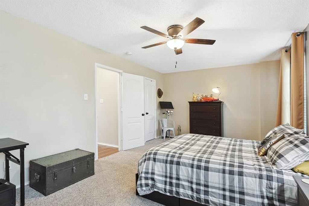 1016 Ridgetop Drive Justin, TX 76247 - Photo 24 of 40 Carpeted bedroom featuring a textured ceiling and a ceiling fan
