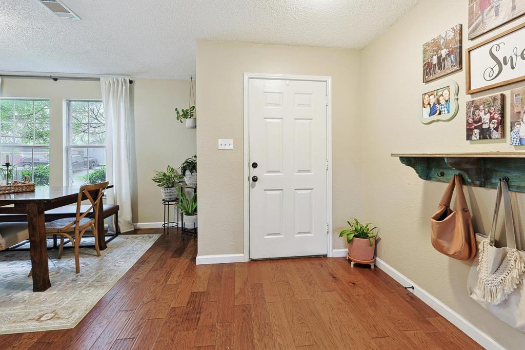 1016 Ridgetop Drive Justin, TX 76247 - Photo 3 of 40 Foyer entrance with a textured ceiling and wood finished floors