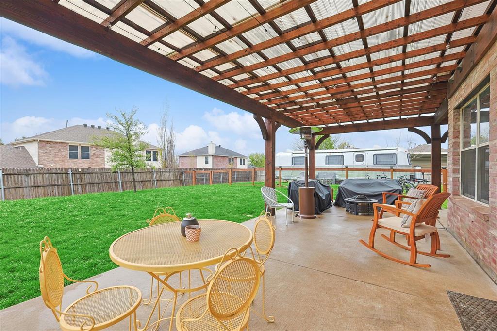 1016 Ridgetop Drive Justin, TX 76247 - Photo 33 of 40 Fenced backyard featuring a pergola and a patio area