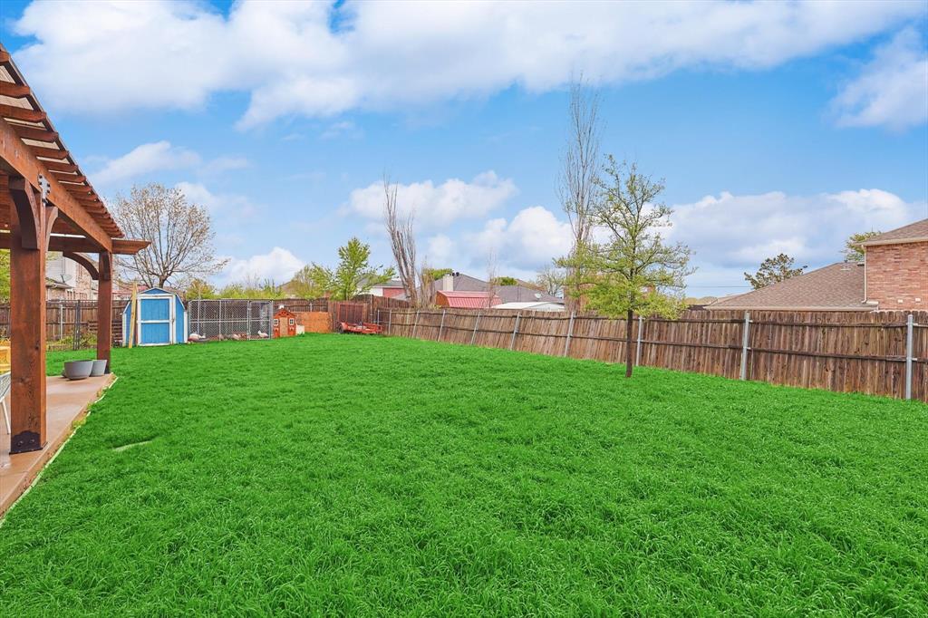 1016 Ridgetop Drive Justin, TX 76247 - Photo 34 of 40 Fenced backyard with a shed