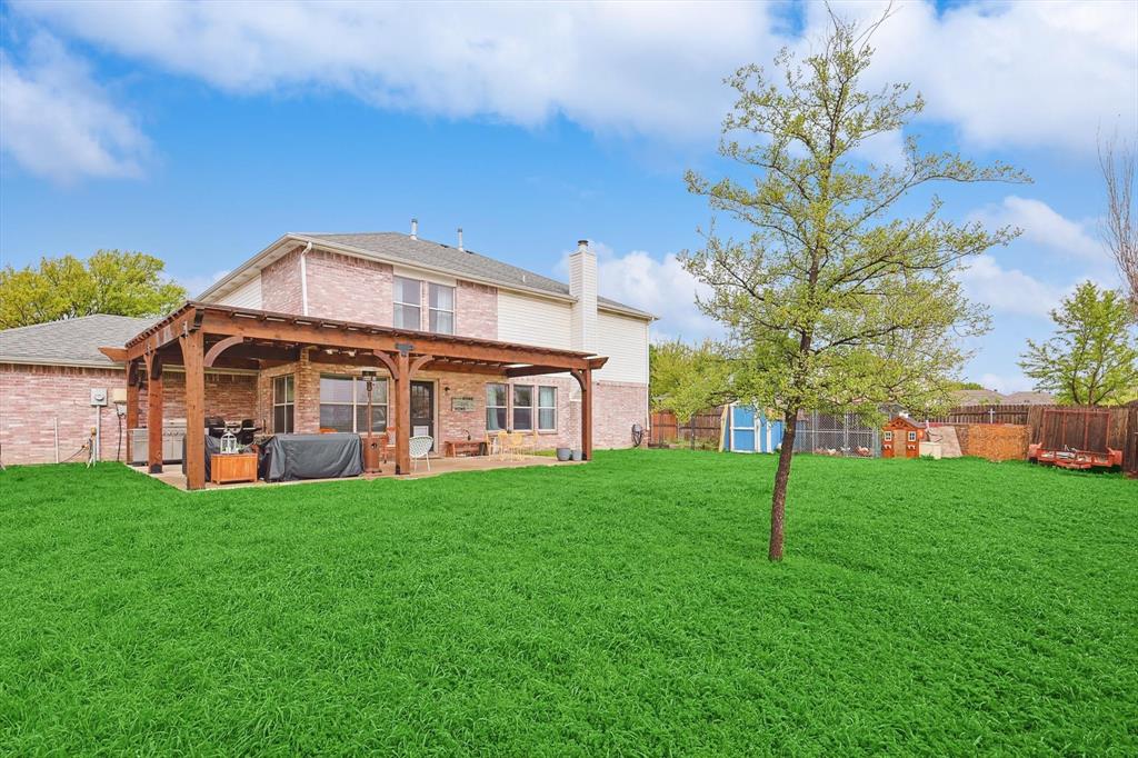 1016 Ridgetop Drive Justin, TX 76247 - Photo 35 of 40 Back of house featuring a shed, a patio area, a chimney, brick siding, and a fenced backyard