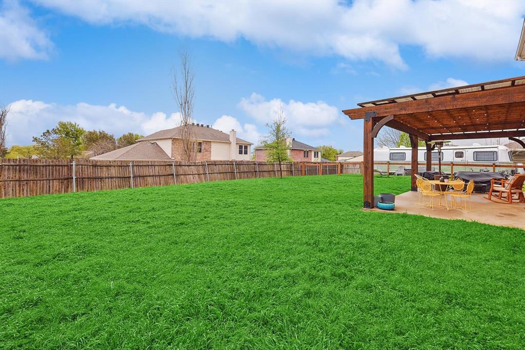 1016 Ridgetop Drive Justin, TX 76247 - Photo 37 of 40 Fenced backyard with a pergola, a patio, and a residential view