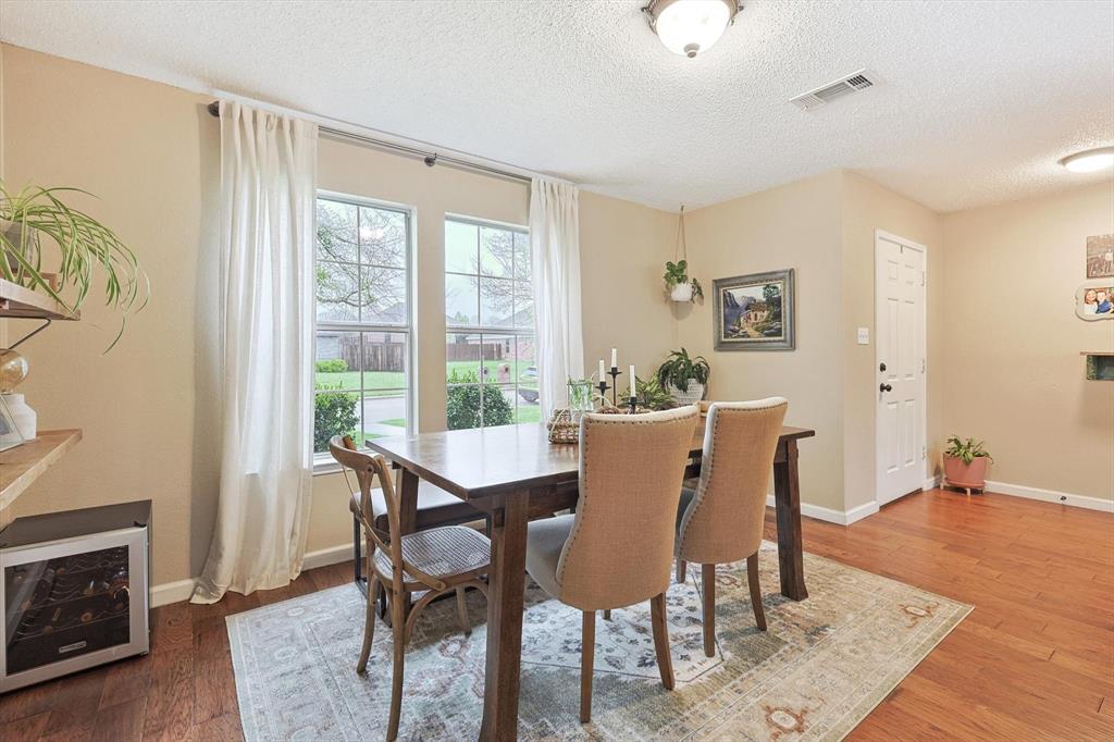 1016 Ridgetop Drive Justin, TX 76247 - Photo 6 of 40 Dining area featuring a textured ceiling and wood finished floors