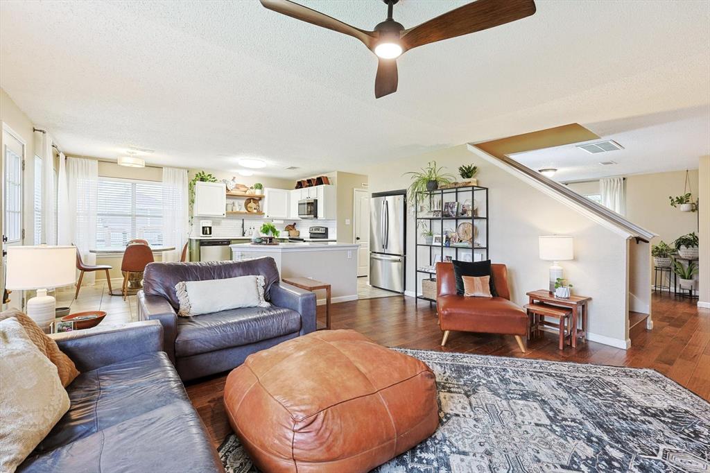 1016 Ridgetop Drive Justin, TX 76247 - Photo 8 of 40 Living room featuring dark wood finished floors, a ceiling fan, and a textured ceiling
