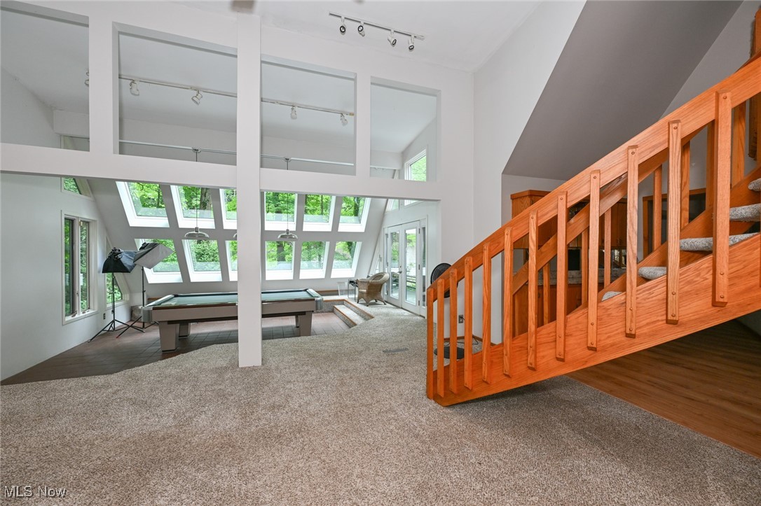 7061 Cascade Road Painesville, OH 44077 - Photo 29 of 49 Living room with dark hardwood / wood-style floors, french doors, high vaulted ceiling, and rail lighting