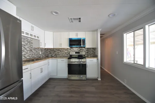 a kitchen with stainless steel appliances granite countertop a stove and a sink