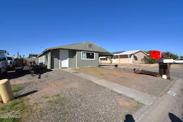 a view of a house with a backyard