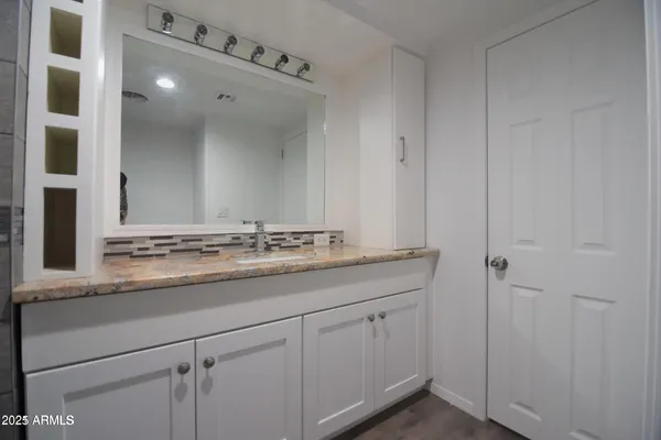 a bathroom with a sink and mirror