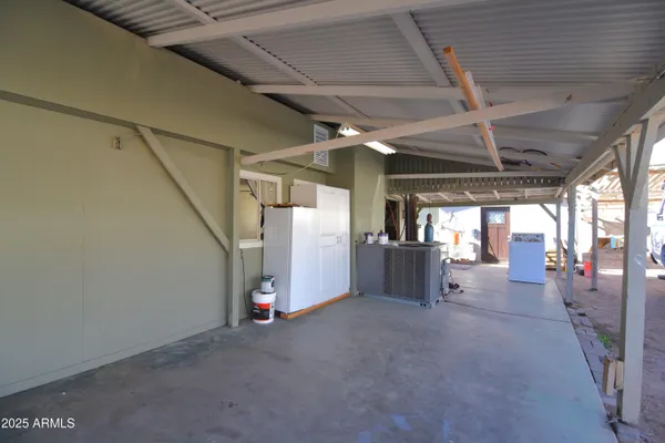 a view of empty room with wooden ceiling