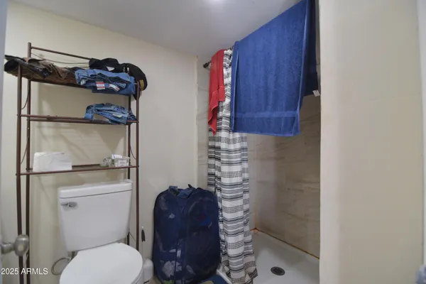 a bathroom with a toilet and a shower