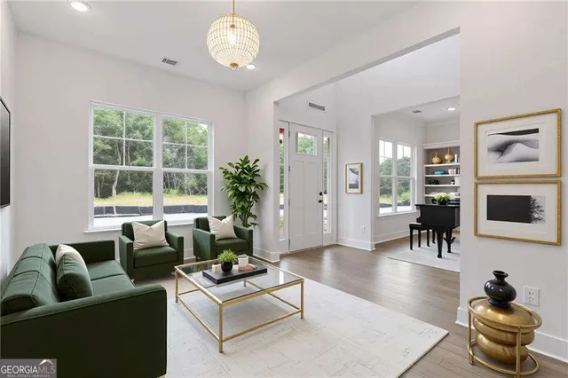 a living room with furniture a chandelier and a window