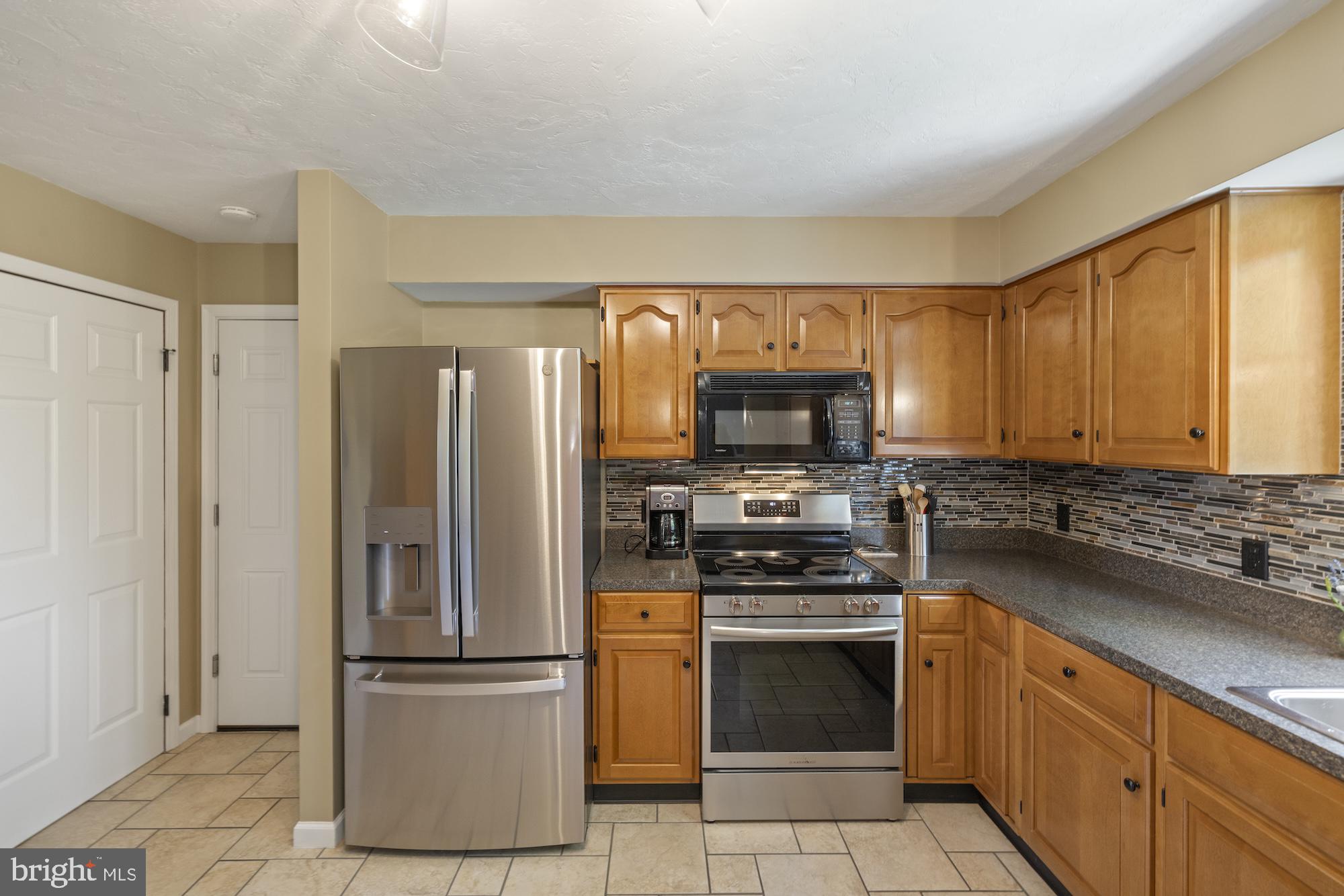 95 White Church Road Gettysburg, PA 17325 - Photo 21 of 59 a kitchen with a refrigerator stove and sink