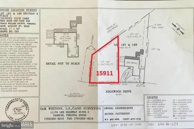 a street sign on a wall next to a building