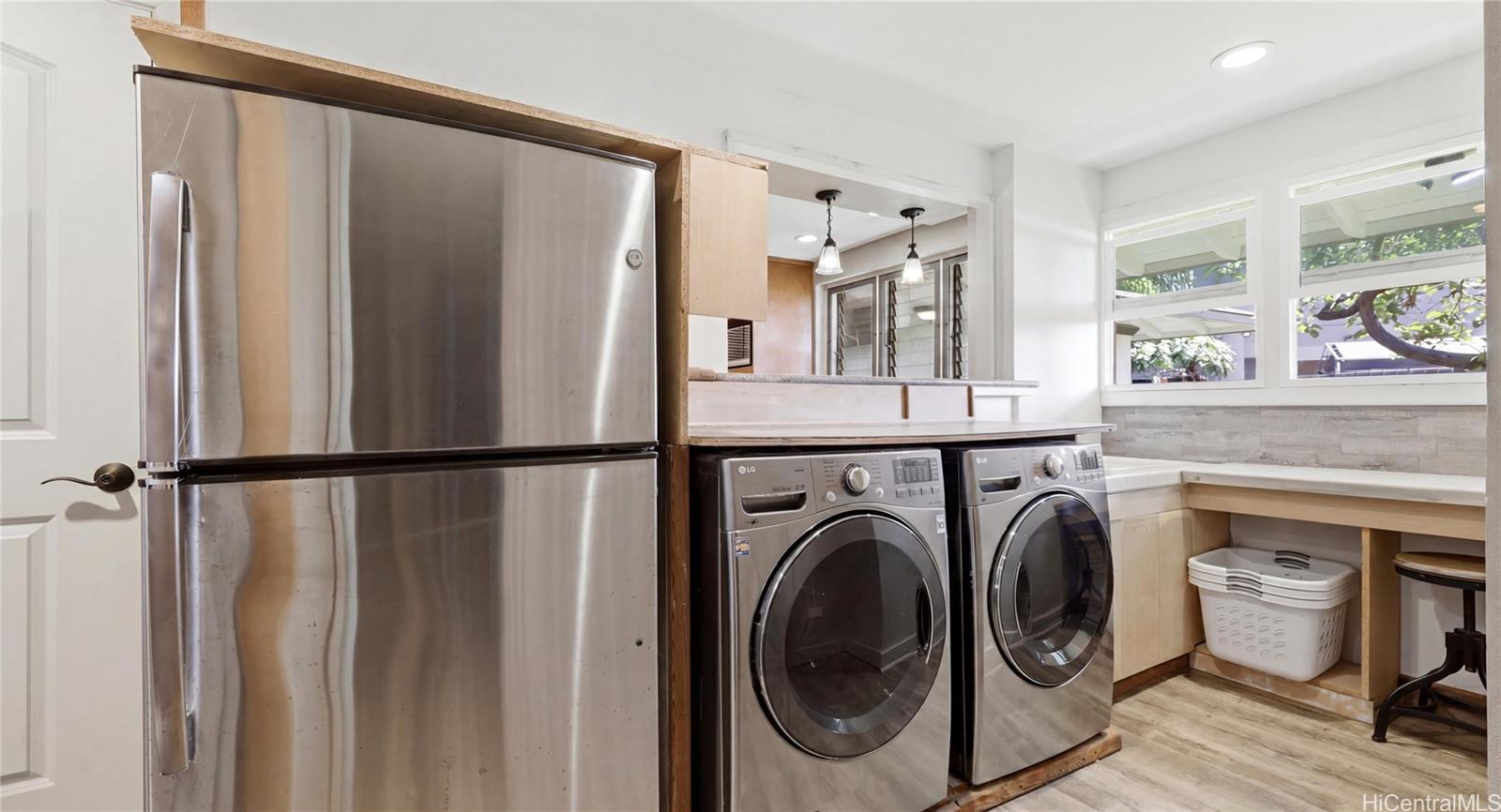91-779 Fort Weaver Road Ewa Beach, HI 96706 - Photo 12 of 25 Dedicated laundry room featuring front-load appliances, folding counter, extra fridge, and integrated storage ideal for use as a pantry.