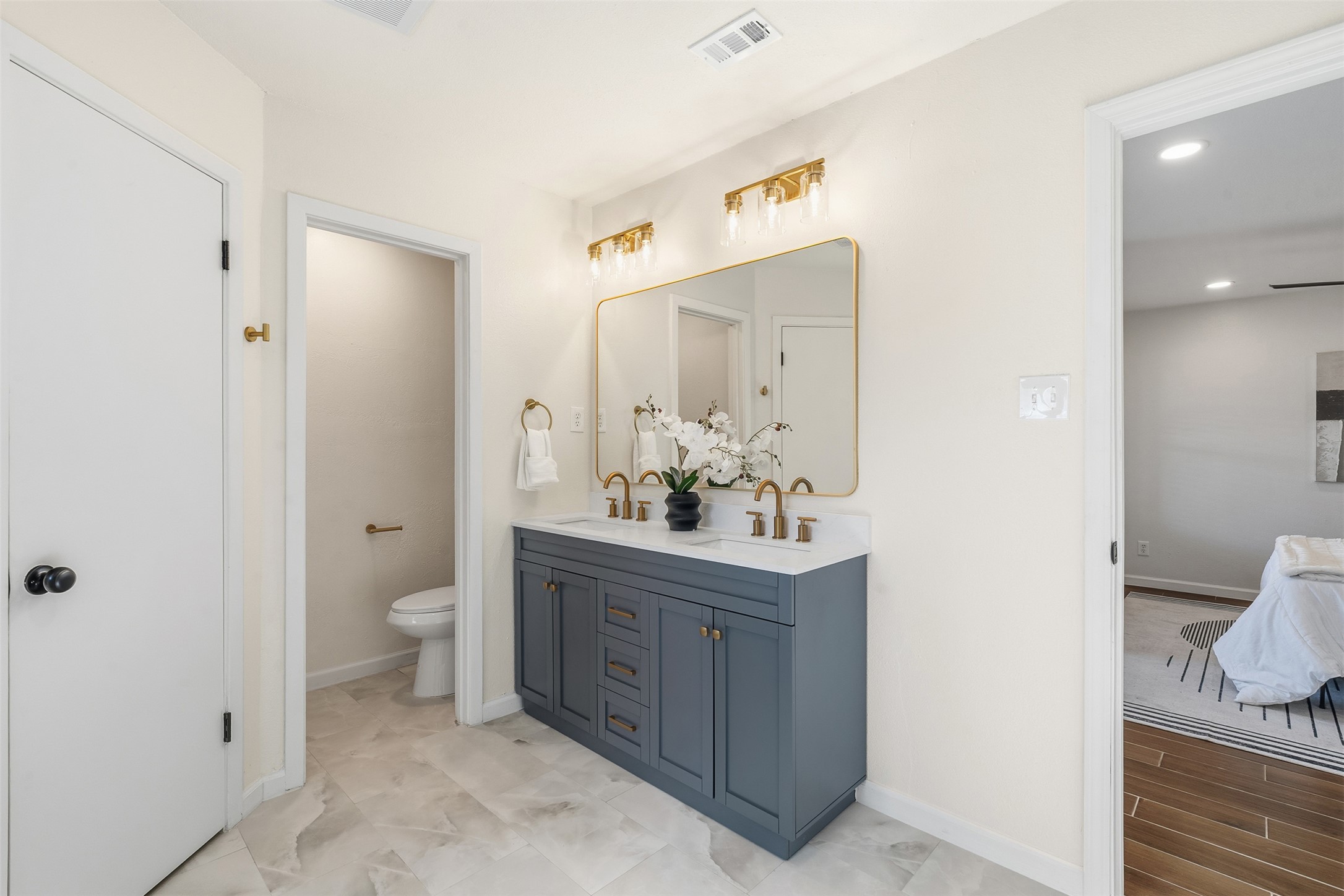 12401 Rusted Nail Cove Austin, TX 78750 - Photo 24 of 34 Bathroom featuring double vanity, connected bathroom, and recessed lighting