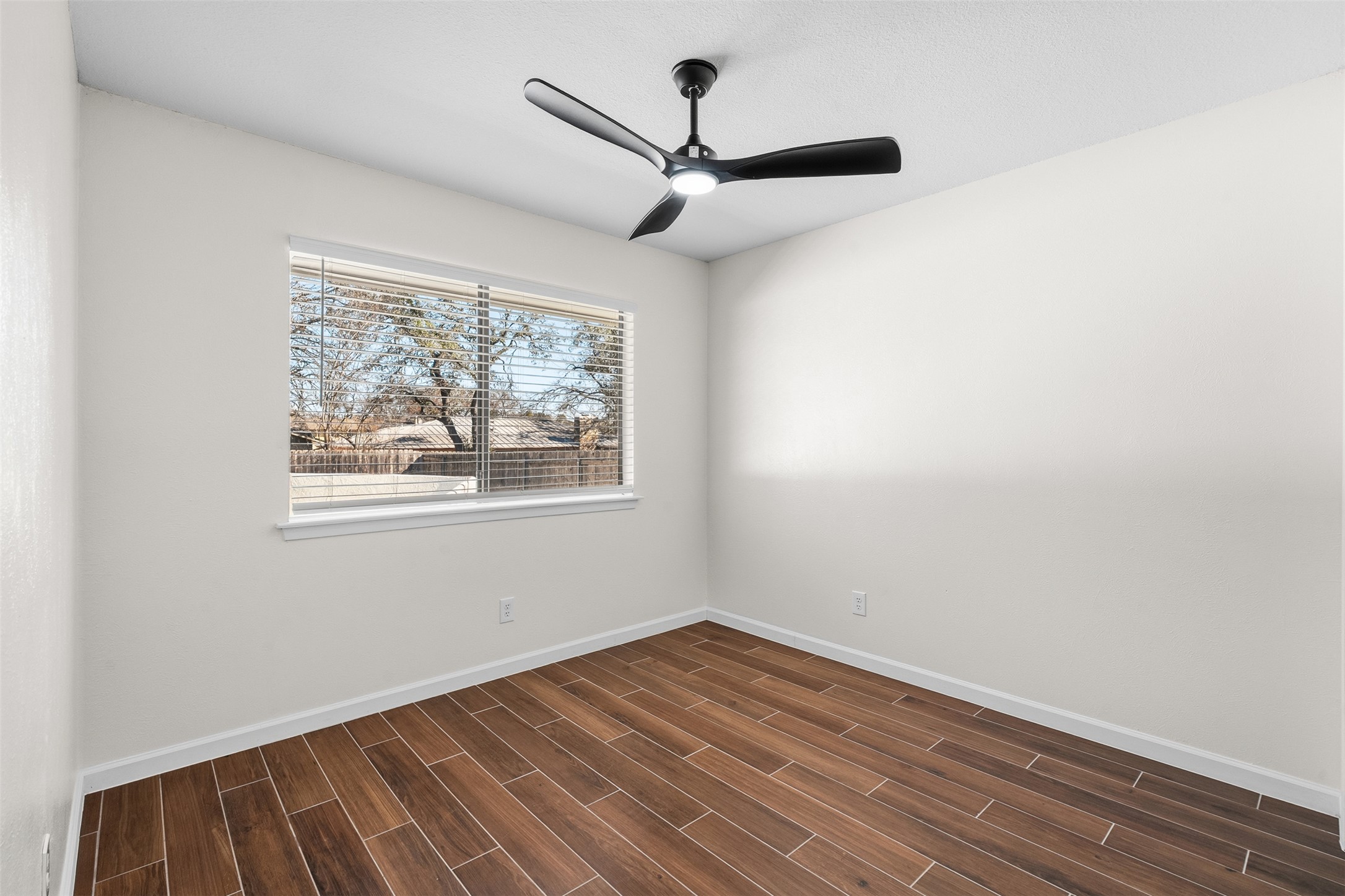 12401 Rusted Nail Cove Austin, TX 78750 - Photo 25 of 34 Unfurnished room featuring wood finish floors and a ceiling fan