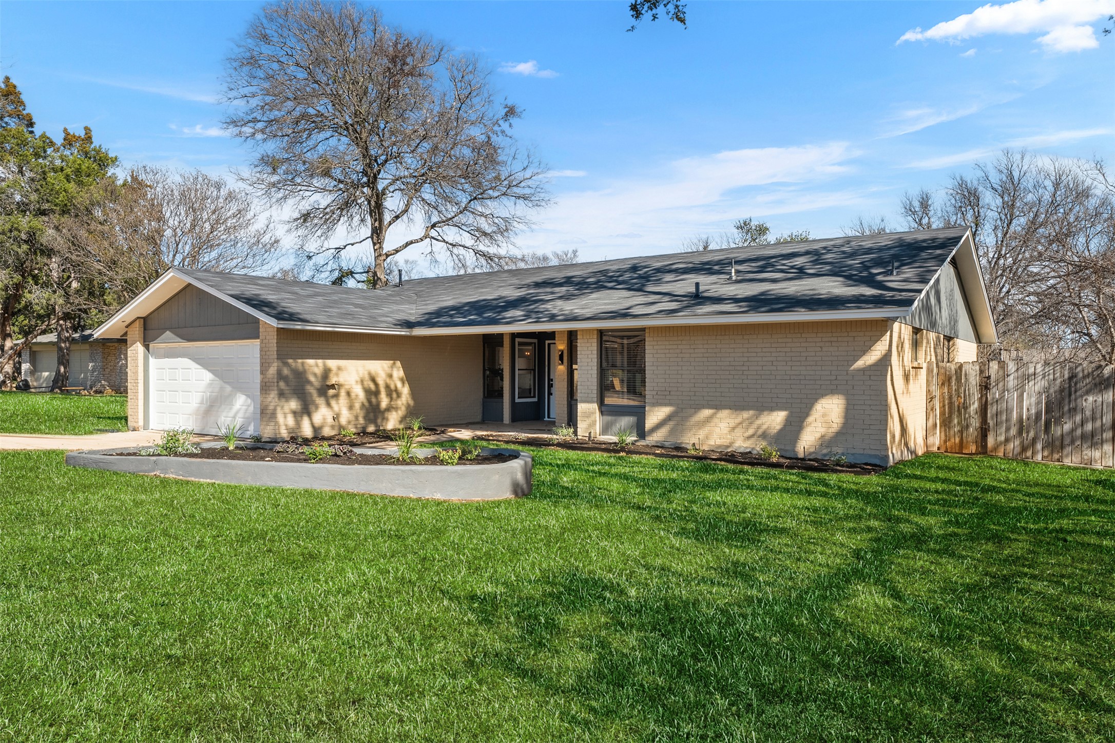 12401 Rusted Nail Cove Austin, TX 78750 - Photo 3 of 34 Ranch-style home with brick siding, an attached garage, and roof with shingles
