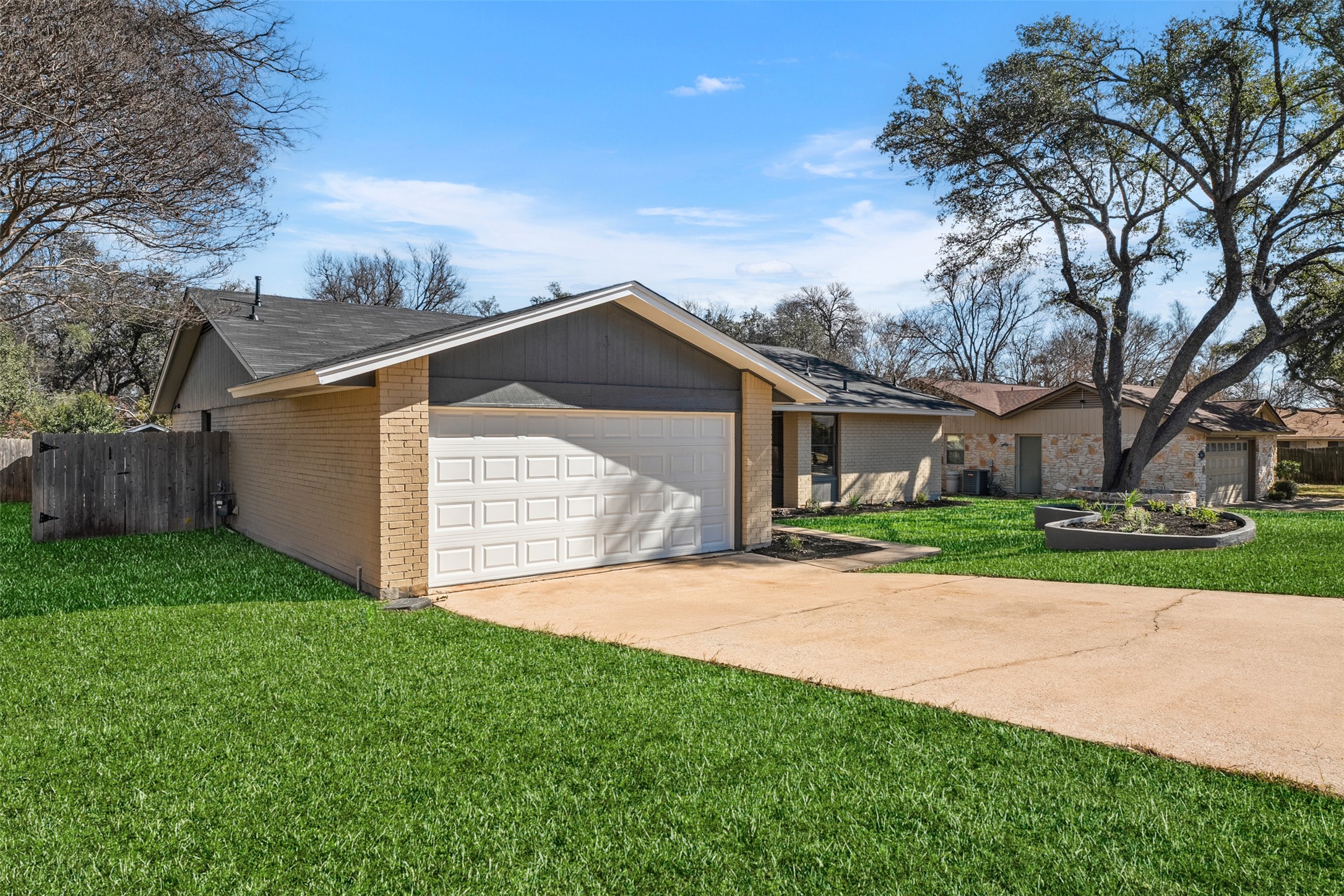 12401 Rusted Nail Cove Austin, TX 78750 - Photo 4 of 34 View of front facade featuring concrete driveway, brick siding, and a garage