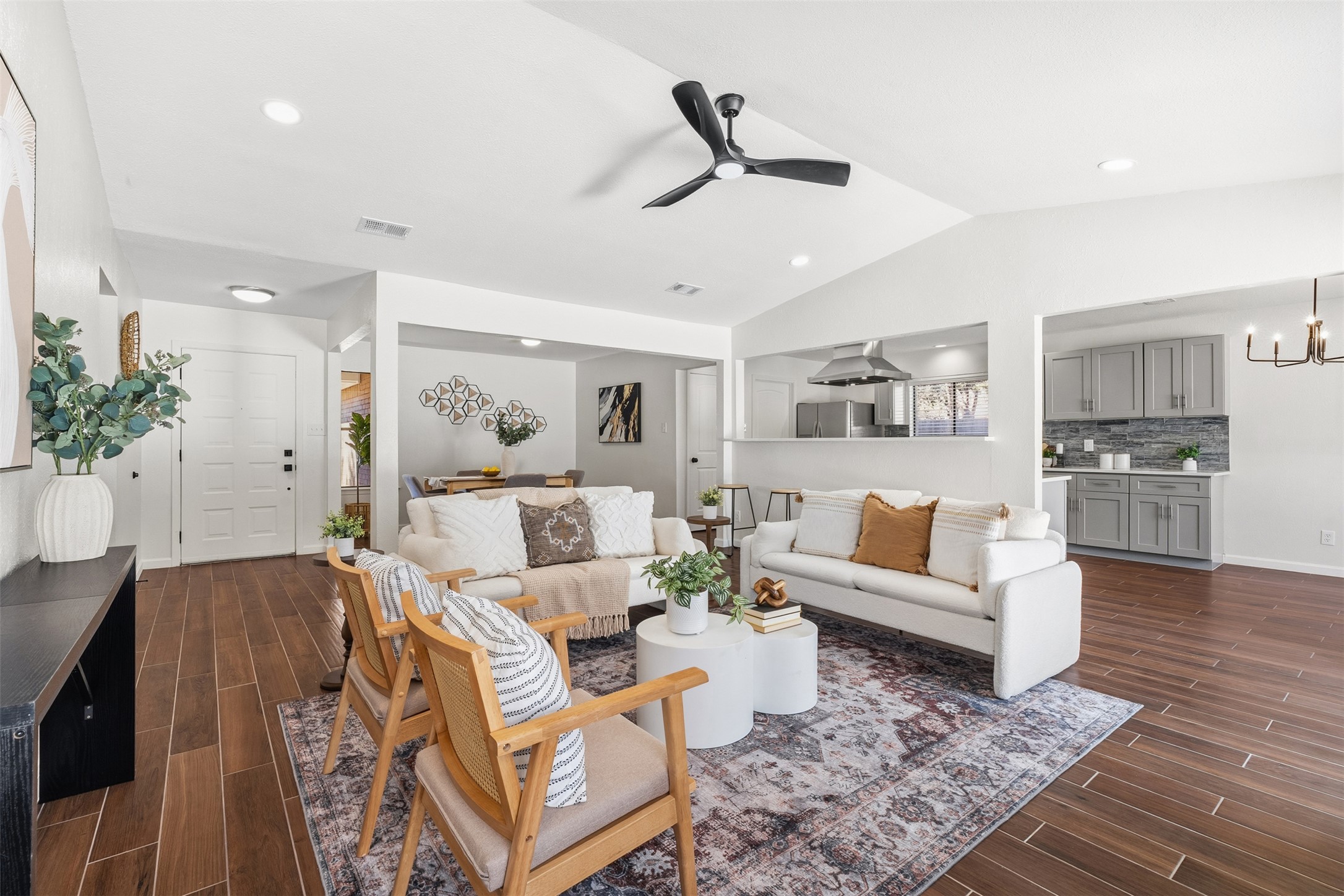 12401 Rusted Nail Cove Austin, TX 78750 - Photo 6 of 34 Living area with wood finish floors, a ceiling fan, vaulted ceiling, a chandelier, and recessed lighting