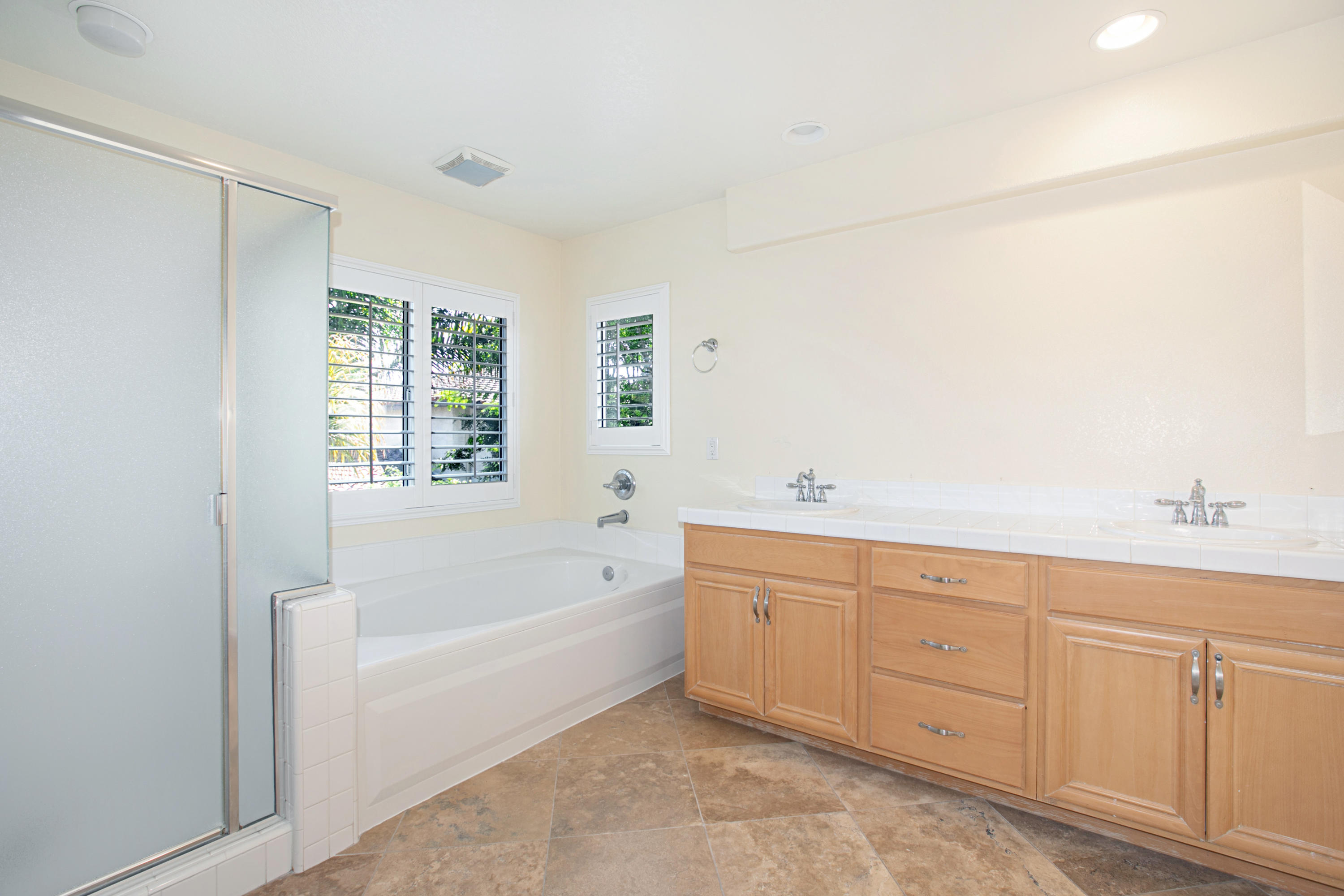 1964 Indiana Drive Oxnard, CA 93036 - Photo 36 of 46 a spacious bathroom with bathtub a shower a sink and a window